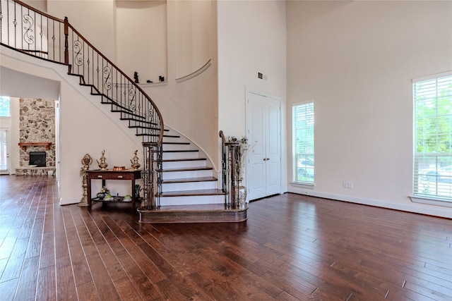 1101 Anchor Ter, Irving, TX 75063 - entryway featuring a towering ceiling, hardwood / wood-style floors, stairway, healthy amount of natural light, and a fireplace