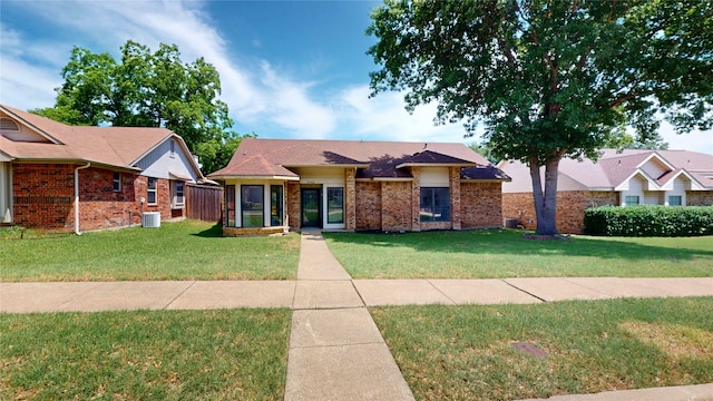 2605 Strother Dr, Garland, TX 75044 - view of front of property featuring a front lawn, brick siding, and central air condition unit