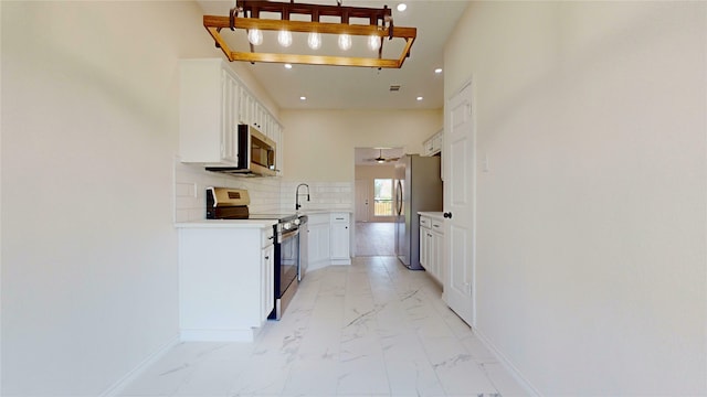 2605 Strother Dr, Garland, TX 75044 - kitchen featuring stainless steel appliances, light marble finish flooring, baseboards, light countertops, and recessed lighting