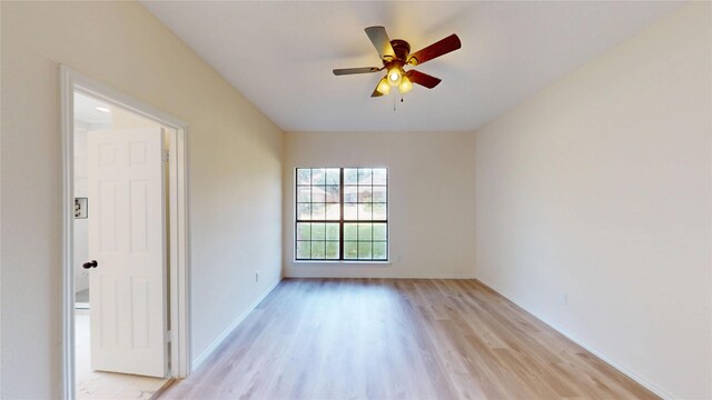 2605 Strother Dr, Garland, TX 75044 - spare room featuring light wood-type flooring, a ceiling fan, and baseboards