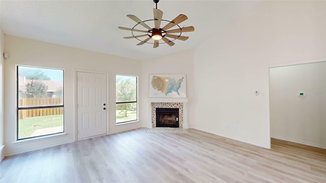 2605 Strother Dr, Garland, TX 75044 - unfurnished living room featuring vaulted ceiling, light wood-style floors, a ceiling fan, a fireplace, and baseboards