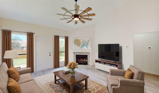 2605 Strother Dr, Garland, TX 75044 - living room with a ceiling fan, healthy amount of natural light, a tile fireplace, light wood finished floors, and vaulted ceiling