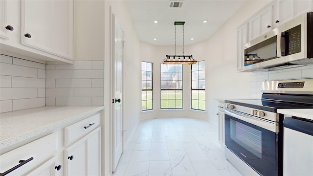 2605 Strother Dr, Garland, TX 75044 - kitchen featuring appliances with stainless steel finishes, light marble finish floors, white cabinets, decorative light fixtures, and recessed lighting