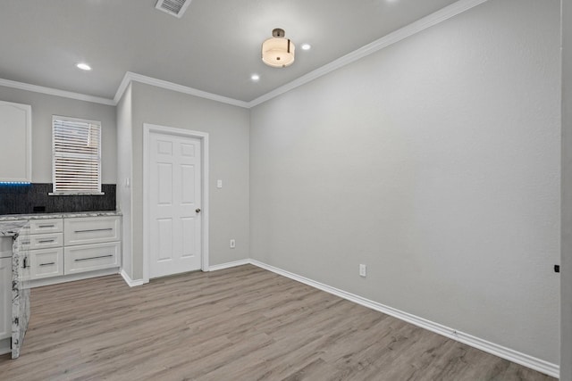 9117 Roundbluff Rd, Plano, TX 75025 - unfurnished dining area featuring light wood-style flooring, baseboards, recessed lighting, and ornamental molding