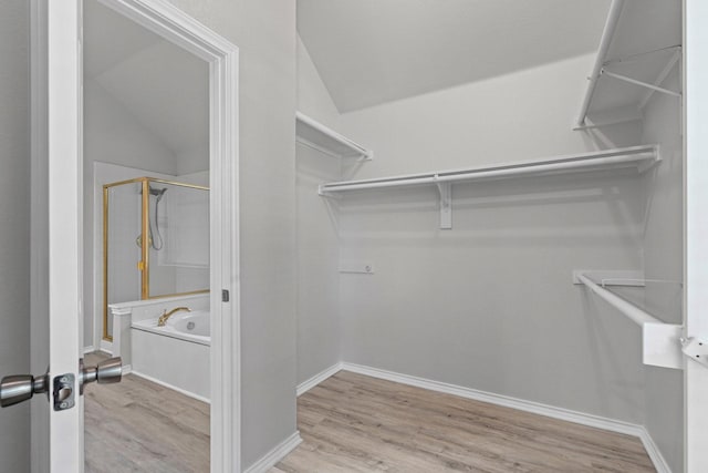 9117 Roundbluff Rd, Plano, TX 75025 - walk in closet featuring wood finished floors