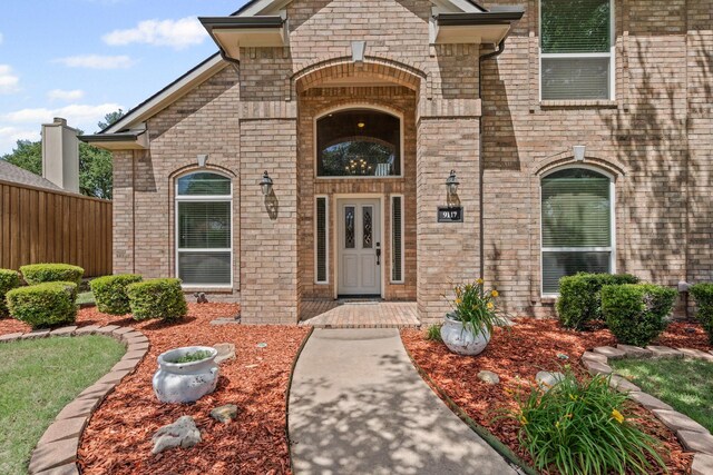 9117 Roundbluff Rd, Plano, TX 75025 - doorway to property with brick siding