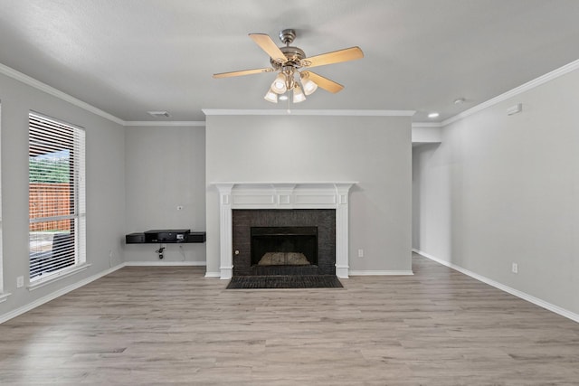 9117 Roundbluff Rd, Plano, TX 75025 - unfurnished living room with wood finished floors, a ceiling fan, crown molding, a fireplace with flush hearth, and baseboards