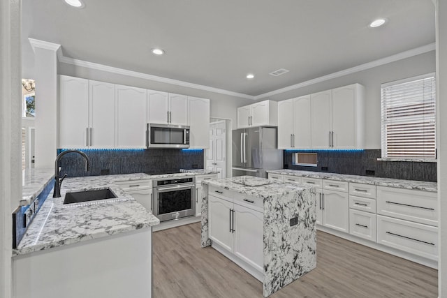 9117 Roundbluff Rd, Plano, TX 75025 - kitchen featuring stainless steel appliances, a sink, tasteful backsplash, light stone countertops, and recessed lighting