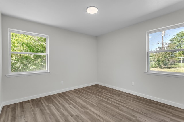 4423 Harvey Dr, Mesquite, TX 75150 - spare room featuring wood finished floors, plenty of natural light, and baseboards