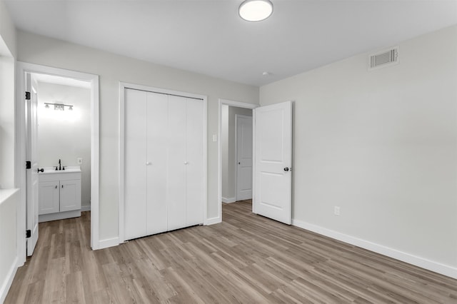 4423 Harvey Dr, Mesquite, TX 75150 - unfurnished bedroom with light wood finished floors, baseboards, and a closet