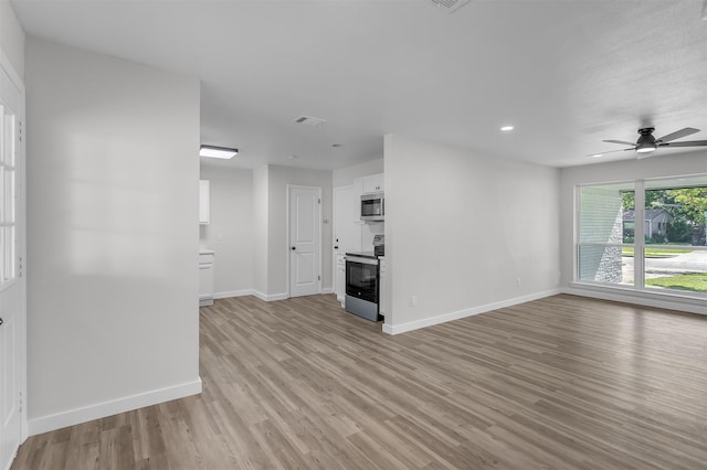 4423 Harvey Dr, Mesquite, TX 75150 - unfurnished living room with light wood finished floors, baseboards, a ceiling fan, and recessed lighting