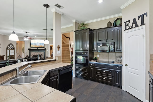 5516 Greenview Ct, North Richland Hills, TX 76148 - kitchen with black appliances, a sink, ceiling fan, a fireplace, and open floor plan
