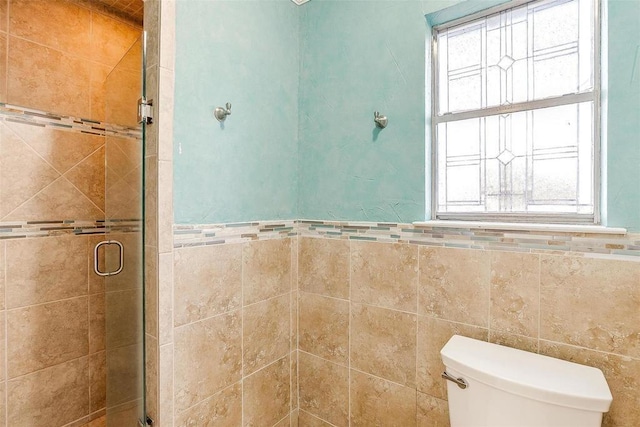 4428 Aspen Way, Haltom City, TX 76137 - full bath with a shower stall, plenty of natural light, toilet, tile walls, and wainscoting
