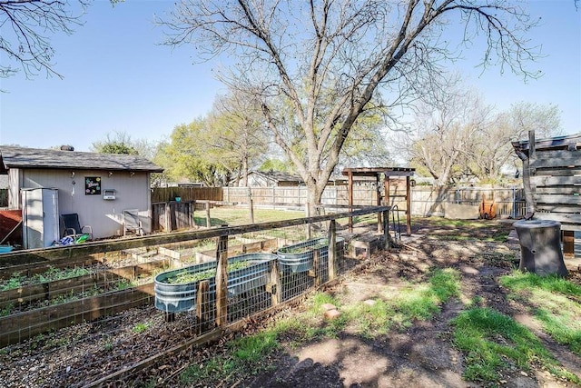 4428 Aspen Way, Haltom City, TX 76137 - fenced backyard featuring a vegetable garden and an outdoor structure