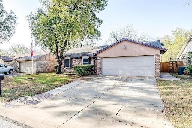 4428 Aspen Way, Haltom City, TX 76137 - view of front facade featuring brick siding, concrete driveway, an attached garage, and cooling unit
