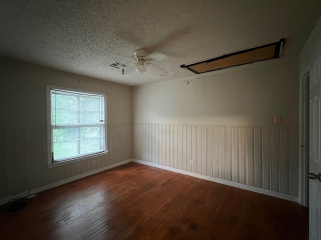 3304 Fadal Ave, Waco, TX 76708 - unfurnished room with attic access, wood finished floors, a textured ceiling, ceiling fan, and a wainscoted wall