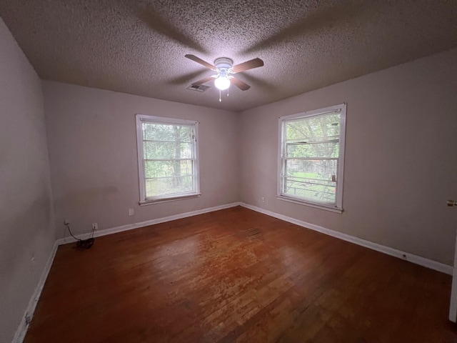 3304 Fadal Ave, Waco, TX 76708 - empty room featuring dark wood-style flooring, ceiling fan, baseboards, and a textured ceiling