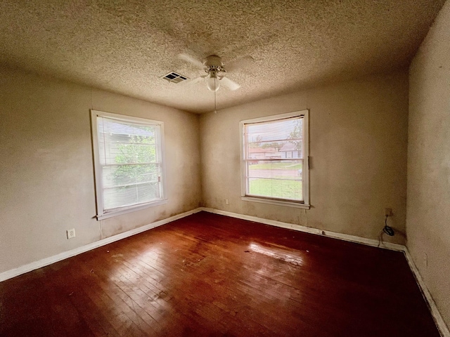 3304 Fadal Ave, Waco, TX 76708 - empty room featuring hardwood / wood-style floors, healthy amount of natural light, ceiling fan, baseboards, and a textured ceiling