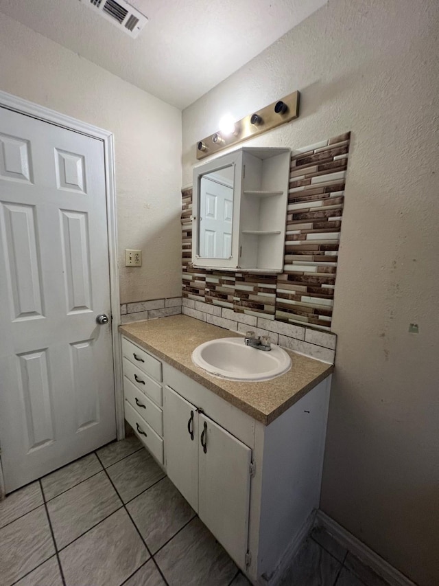 3304 Fadal Ave, Waco, TX 76708 - bathroom with vanity, backsplash, and tile patterned floors