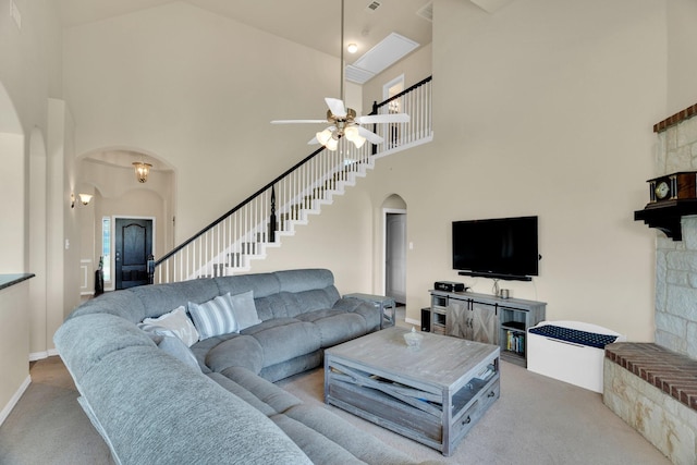 136 Devonshire Dr, Waxahachie, TX 75167 - carpeted living room with arched walkways, a high ceiling, ceiling fan, and stairs