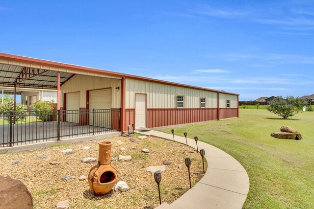 136 Devonshire Dr, Waxahachie, TX 75167 - view of side of home with a detached garage, an outdoor structure, and a pole building