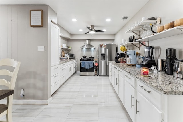420 Shady Oaks Ln, Paris, TX 75460 - kitchen featuring open shelves, stainless steel appliances, wall chimney exhaust hood, a ceiling fan, and white cabinetry