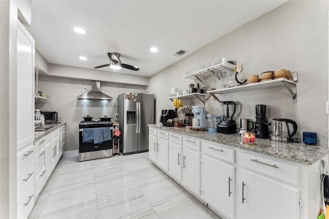 420 Shady Oaks Ln, Paris, TX 75460 - kitchen with appliances with stainless steel finishes, open shelves, wall chimney range hood, a ceiling fan, and white cabinets