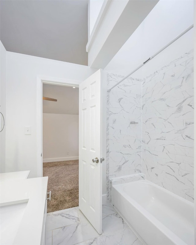 5105 Vandelia St, Dallas, TX 75235 - bathroom with vanity, marble look tiles, and bathing tub / shower combination