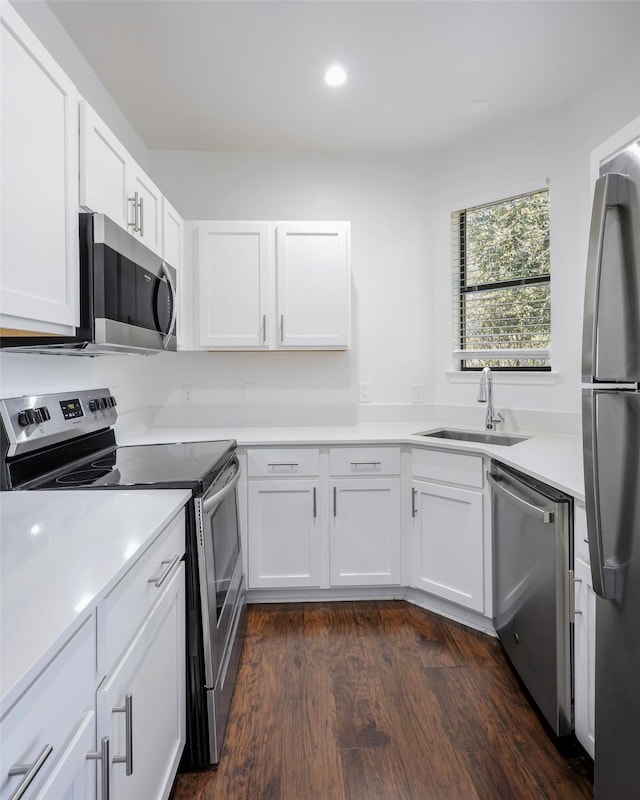 5105 Vandelia St, Dallas, TX 75235 - kitchen featuring appliances with stainless steel finishes, a sink, white cabinetry, and recessed lighting