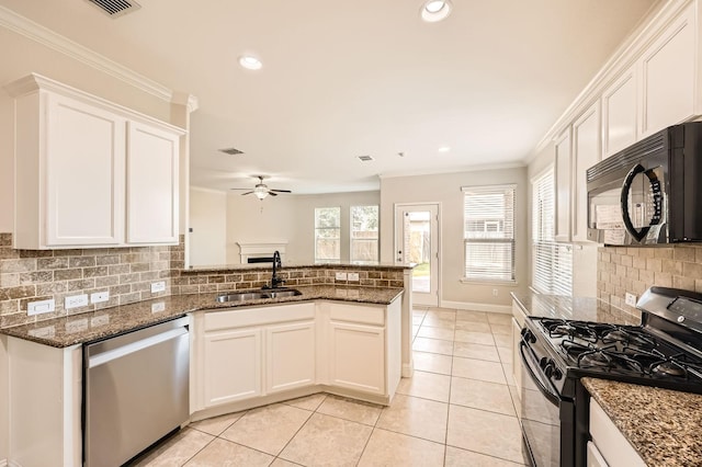 1017 Oarlock Dr, Crowley, TX 76036 - kitchen featuring black microwave, stainless steel dishwasher, gas stove, a sink, and backsplash