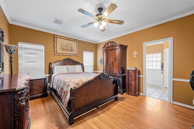 209 Keswick Dr, Hewitt, TX 76643 - bedroom featuring light wood-style floors, crown molding, ensuite bathroom, ceiling fan, and baseboards