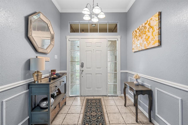 209 Keswick Dr, Hewitt, TX 76643 - foyer with a chandelier, crown molding, light tile patterned flooring, a textured wall, and baseboards