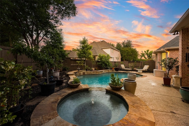 603 Regency Xing, Southlake, TX 76092 - pool at dusk with a fenced backyard, a patio, and a pool with connected hot tub