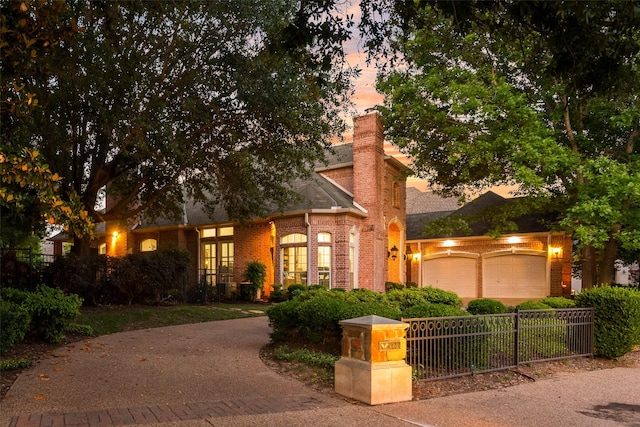 603 Regency Xing, Southlake, TX 76092 - view of front of home with brick siding, a garage, driveway, a chimney, and a shingled roof