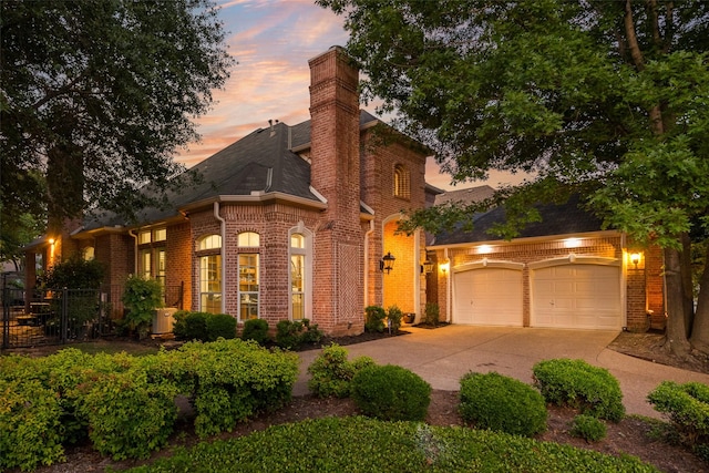 603 Regency Xing, Southlake, TX 76092 - view of front of property with brick siding, driveway, an attached garage, and a chimney