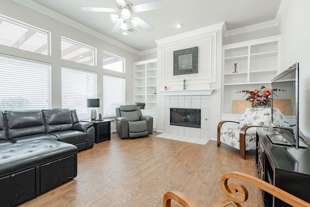 1415 Clubhill Dr, Rockwall, TX 75087 - living area with a ceiling fan, ornamental molding, a tile fireplace, wood finished floors, and recessed lighting