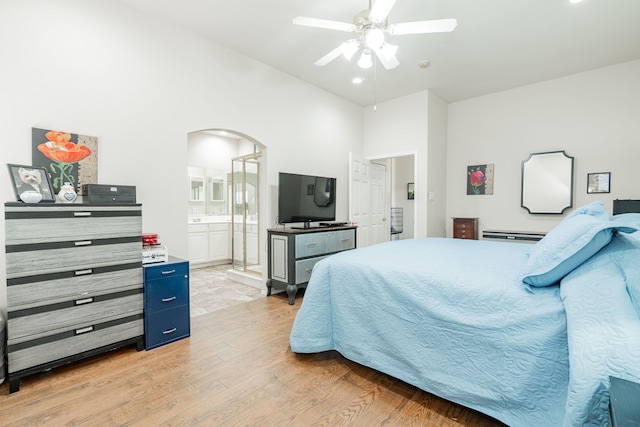 1415 Clubhill Dr, Rockwall, TX 75087 - bedroom with light wood finished floors, arched walkways, high vaulted ceiling, connected bathroom, and ceiling fan