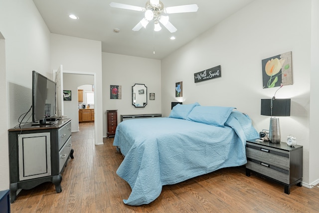 1415 Clubhill Dr, Rockwall, TX 75087 - bedroom featuring arched walkways, wood finished floors, recessed lighting, baseboards, and ensuite bath