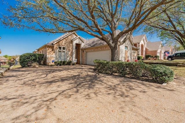 1415 Clubhill Dr, Rockwall, TX 75087 - view of front of home with brick siding, a garage, a residential view, and driveway