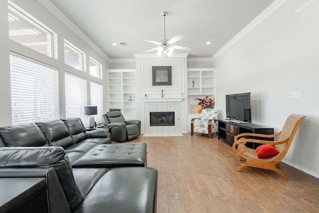 1415 Clubhill Dr, Rockwall, TX 75087 - living room featuring ceiling fan, wood finished floors, crown molding, a tile fireplace, and recessed lighting
