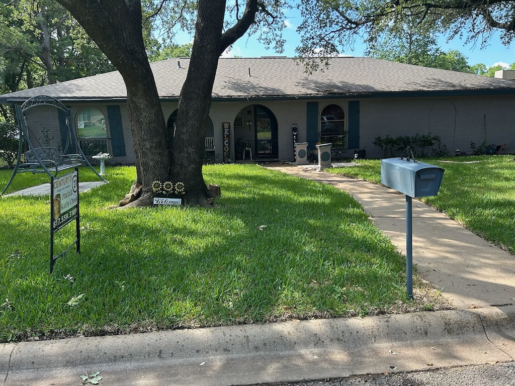 1229 Surry Place Dr, Cleburne, TX 76033 - ranch-style house with a front yard and a shingled roof