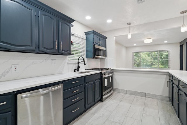 1006 Tower Dr, Cedar Hill, TX 75104 - kitchen featuring stainless steel appliances, a sink, healthy amount of natural light, hanging light fixtures, and recessed lighting