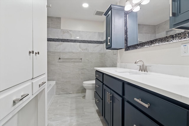 1006 Tower Dr, Cedar Hill, TX 75104 - bathroom featuring vanity, marble finish floors, toilet, and tile walls