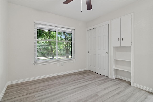 1006 Tower Dr, Cedar Hill, TX 75104 - unfurnished bedroom featuring light wood-style floors, multiple windows, baseboards, and a closet