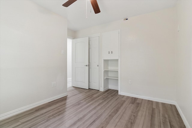 1006 Tower Dr, Cedar Hill, TX 75104 - unfurnished bedroom with light wood-style floors, baseboards, ceiling fan, and a closet