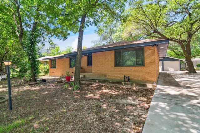 1006 Tower Dr, Cedar Hill, TX 75104 - ranch-style home featuring brick siding, a detached garage, and an outbuilding