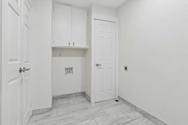 1006 Tower Dr, Cedar Hill, TX 75104 - laundry area featuring cabinet space, light marble finish flooring, electric dryer hookup, and baseboards