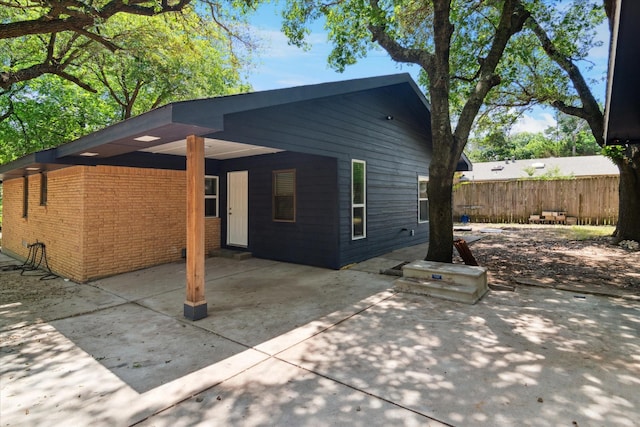 1006 Tower Dr, Cedar Hill, TX 75104 - back of property with a patio, a carport, and brick siding