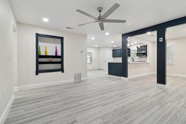 1006 Tower Dr, Cedar Hill, TX 75104 - unfurnished living room featuring light wood-type flooring, recessed lighting, ceiling fan, baseboards, and a sink