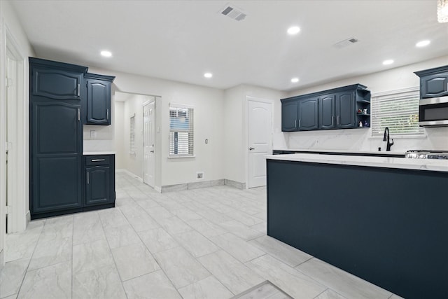 1006 Tower Dr, Cedar Hill, TX 75104 - kitchen with stainless steel microwave, light countertops, a sink, recessed lighting, and open shelves